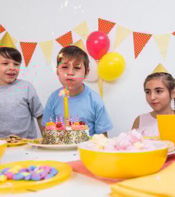 birthday boy blowing candle with his friends 23 2148046249